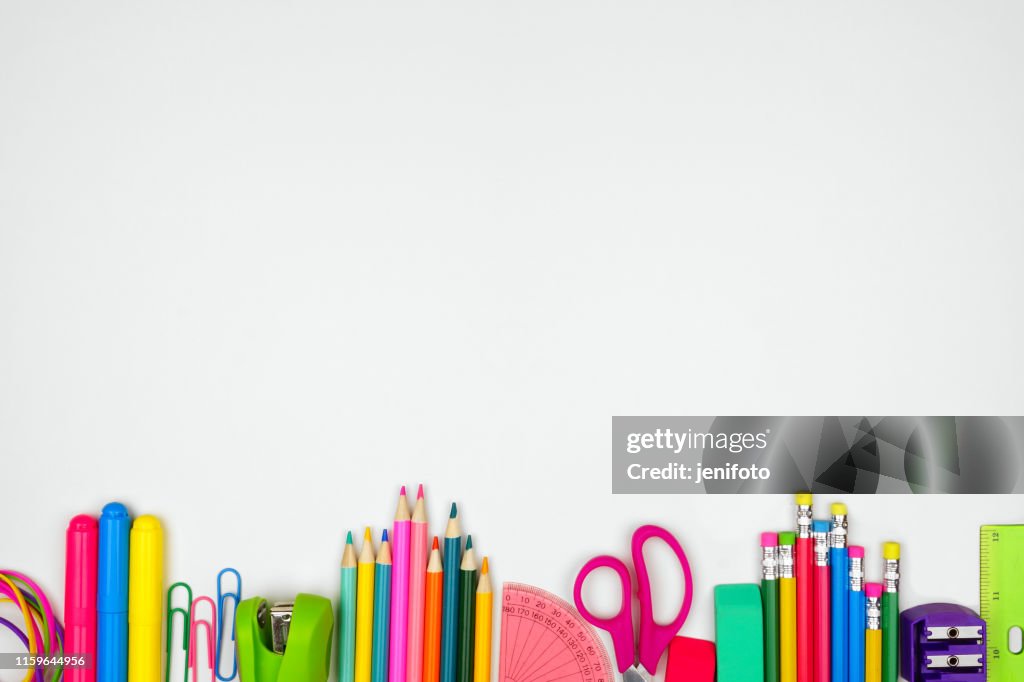School supplies bottom border, top view on a white background with copy space. Back to school.