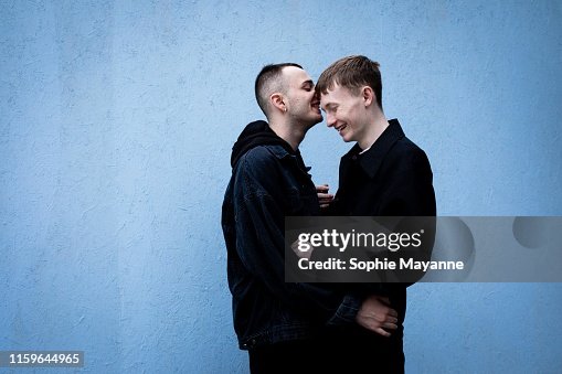 A young LGBT couple laughing and hugging A young LGBT couple laughing and hugging