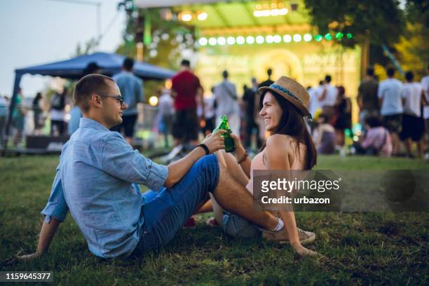 couple toasting on a music festival - music festival grass stock pictures, royalty-free photos & images