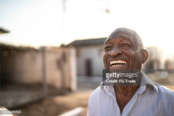 portrait of smiling latin senior man looking away - man side way looking imagens e fotografias de stock