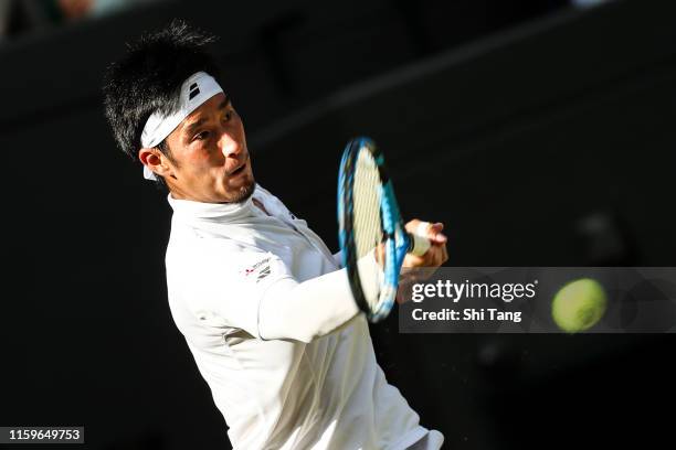 Yuichi Sugita of Japan plays a forehand in his Men's Singles first round match against Rafael Nadal of Spain during Day two of The Championships -...