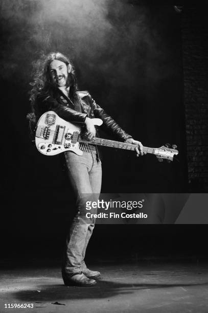 Lemmy Kilmister, British rock bassist and singer with British heavy metal band Motorhead, poses with his bass guitar, circa 1978.