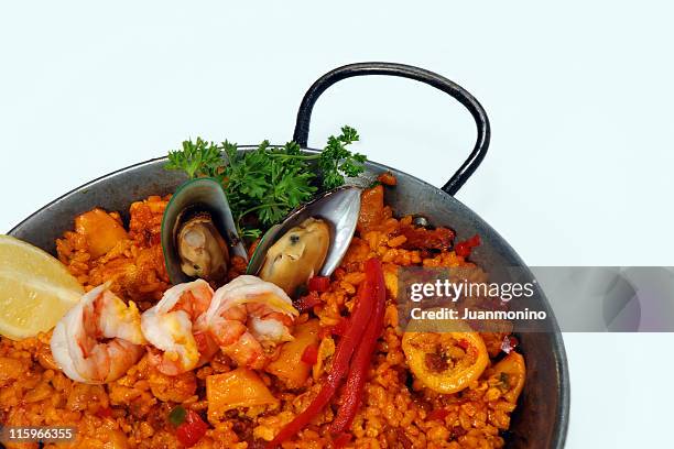 sea food paella isolated on white - paella stockfoto's en -beelden