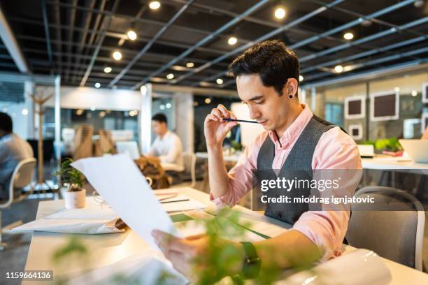 hearing impaired architect working in the office - hearing loss at work stock pictures, royalty-free photos & images