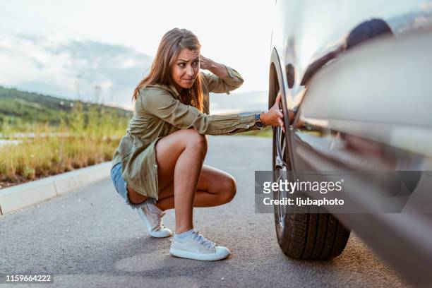 this is going to ruin my trip! - flat tyre stock pictures, royalty-free photos & images