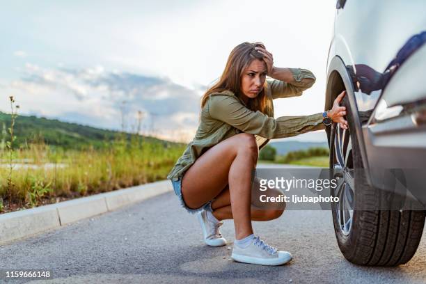 woman with broken down car flat tire - flat tyre stock pictures, royalty-free photos & images