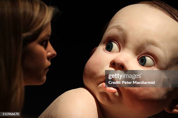 Ron Mueck's 'Big Baby' sculpture appears to look round at a visitor to the Masterpieces Exhibition at Christie's on June 13, 2011 in London, England....