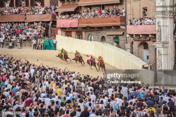 Jockeys compete at the historical horse race Palio di Siena 2019 on July 02, 2019 in Siena, Italy. The Palio horse race in Siena takes place annually...