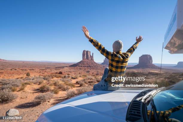 young man with rental motor home enjoying road trip in usa - trailer park imagens e fotografias de stock