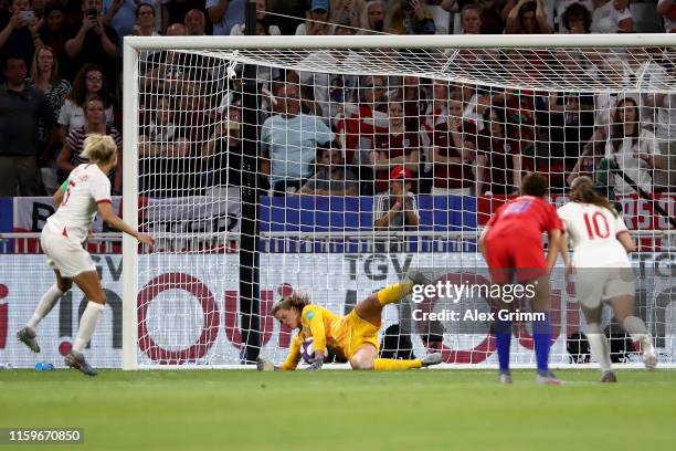 Alyssa Naeher of the USA saves a penalty from Steph Houghton of England during the 2019 FIFA Women's World Cup France Semi Final match between...