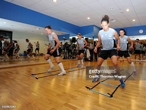 Ceila Okoyino da Mbabi and Almuth Schult exercise during a Germany training session at Fitness First club on June 13, 2011 in Frankfurt am Main,...