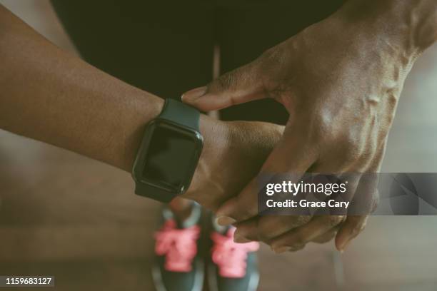 close-up of woman in athletic wear with smart watch - exercise watch stock-fotos und bilder