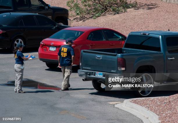 Agents check a vehicle outside the Cielo Vista Mall Wal-Mart where a shooting left 20 people dead in El Paso, Texas, on August 4, 2019. - Texas...