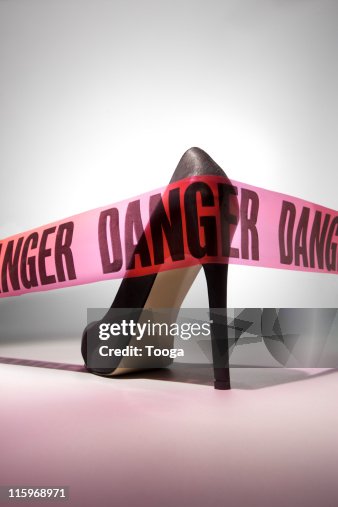 "Danger" tape around stiletto heel "Danger" tape around stiletto heel