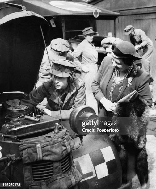 Queen Elizabeth visits her daughter Princess Elizabeth, who is training as an ATS mechanic at a training centre in southern England, April 1945. At...