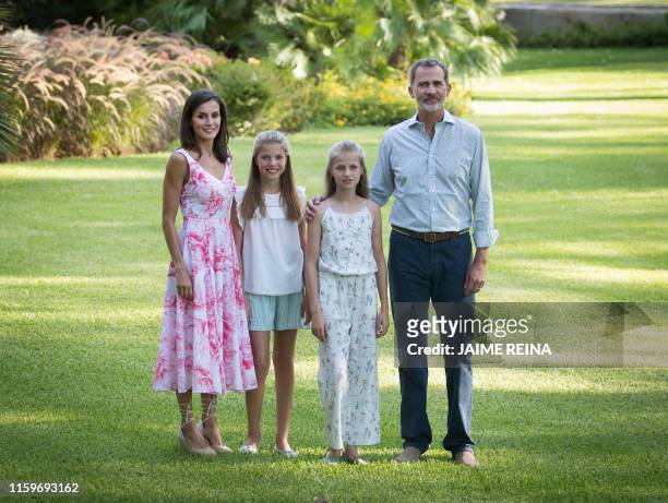 Spanish king Felipe VI and queen Letizia pose with their daughters Spanish crown princess Leonor and princess Sofia in the gardens at the Marivent...