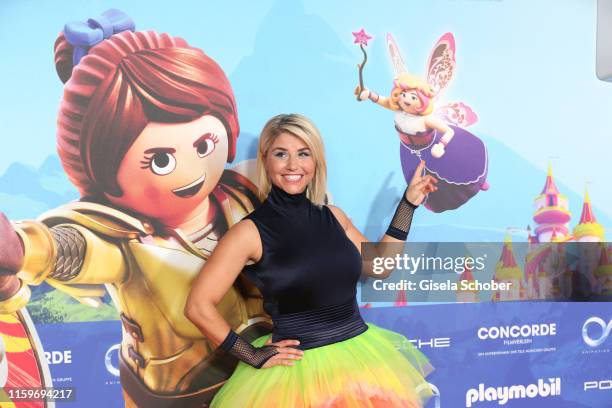 Beatrice Egli wearing a rainbow skirt during the premiere of the movie "Playmobil der Film" at Mathaeser Filmpalast on August 4, 2019 in Munich,...