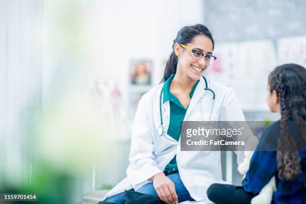 doctor comforting a girl - west asia stock pictures, royalty-free photos & images