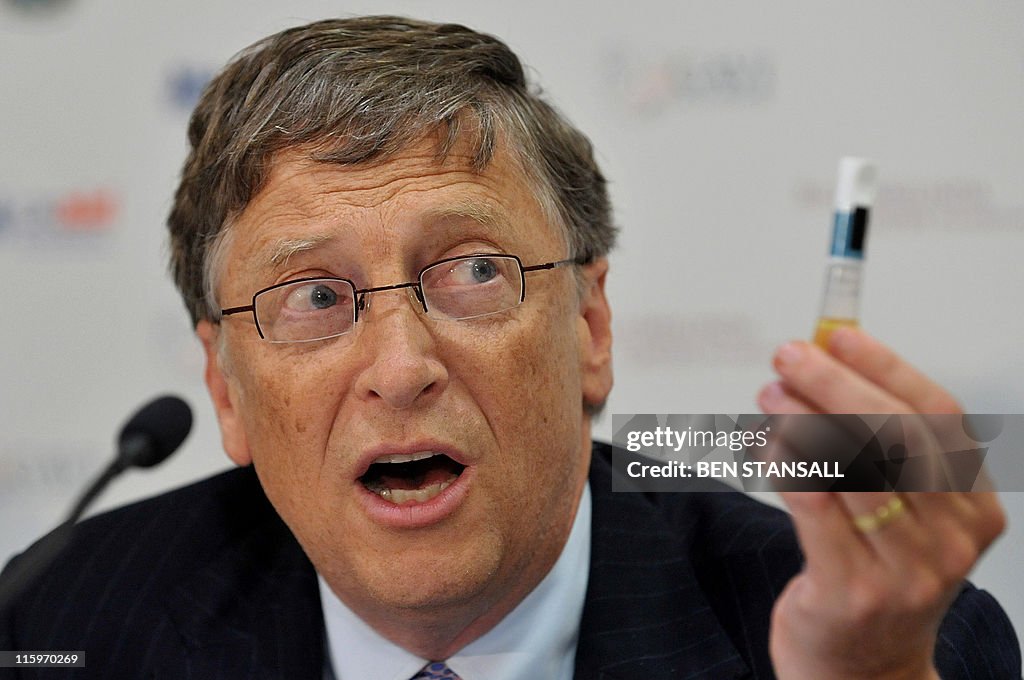 Microsoft tycoon Bill Gates holds a vial