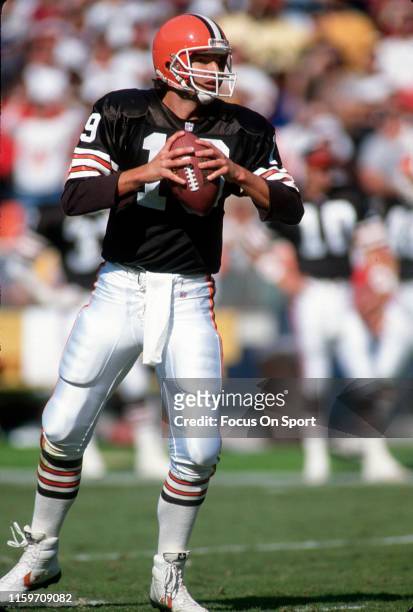 Bernie Kosar of the Cleveland Browns drops back to pass against the Washington Redskins during an NFL Football game October 13, 1991 at RFK Stadium...