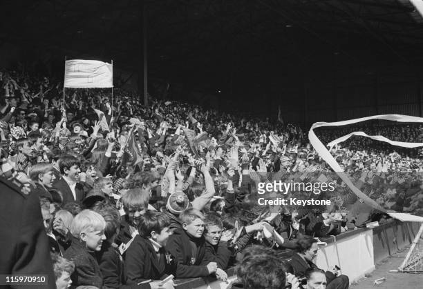 Manchester United fans watch their team beat West Ham 6-1 at Upton Park to become the League champions, London, 6th May 1967.