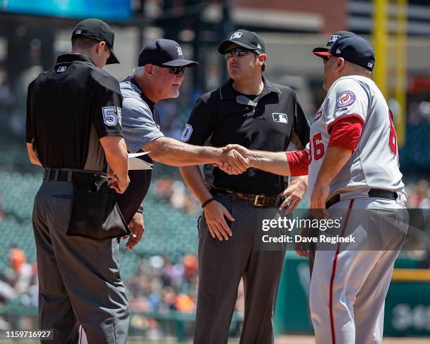 Manager Ron Gardenhire of the Detroit Tigers shakes hands with batting practice pitcher Ali Modami of the Washington Nationals before the start of a...
