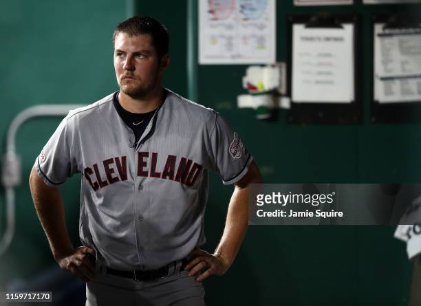 Starting pitcher Trevor Bauer of the Cleveland Indians watches from the dugout after leaving the game during the 7th inning of the game against the...