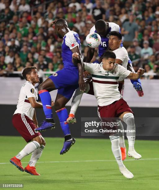 Andrew Jean Baptiste and Frantzdy Pierrot of Haiti attempt a header over Carlos Salcedo and Jesus Gallardo of Mexico at State Farm Stadium on July...