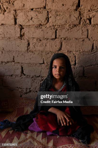 Six-year-old Farzana sits in her family’s shelter in the Regreshan IDP camp in Herat Province, Afghanistan, June 17, 2019. Her father, Abdul Nabi,...