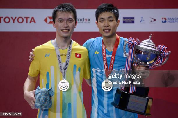 Tien Chen of Taipei poses with the trophy with runner-up NG Ka Long Angus of Hong Kong during the award presentation after their men's singles final...