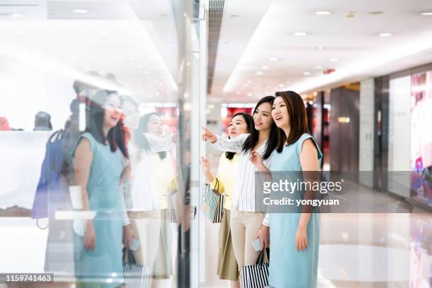 asian women window shopping in a mall - yongyuan hongkong stock pictures, royalty-free photos & images