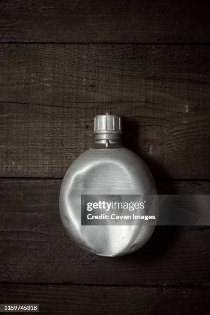 old canteen on a wood table - water canteen stock pictures, royalty-free photos & images