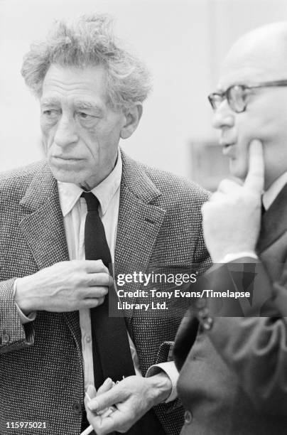 Swiss sculptor and painter Alberto Giacometti at the Tate Gallery, London, with his friend Louis Clayeux, July 1965.