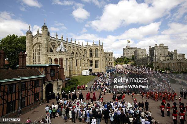 Crowds watch members of the Order of the Garter arrive for the annual Order of the Garter Service at St George's Chapel, Windsor Castle on June 13,...