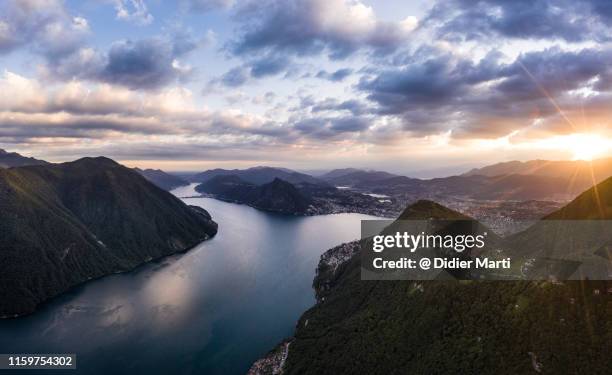 dramatic sunset over lugano in switzerland - schweiz stadt stock-fotos und bilder