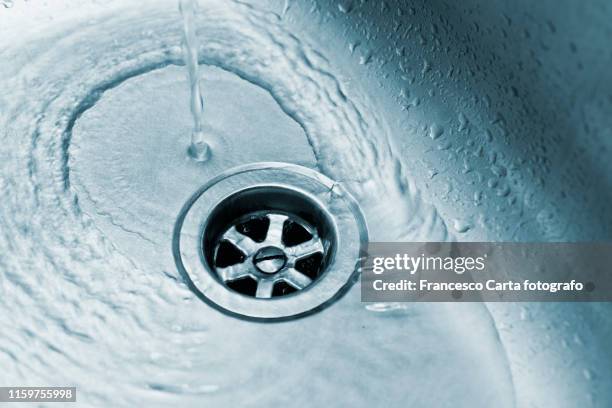 close-up of drain with water - kitchen sink running water stock pictures, royalty-free photos & images