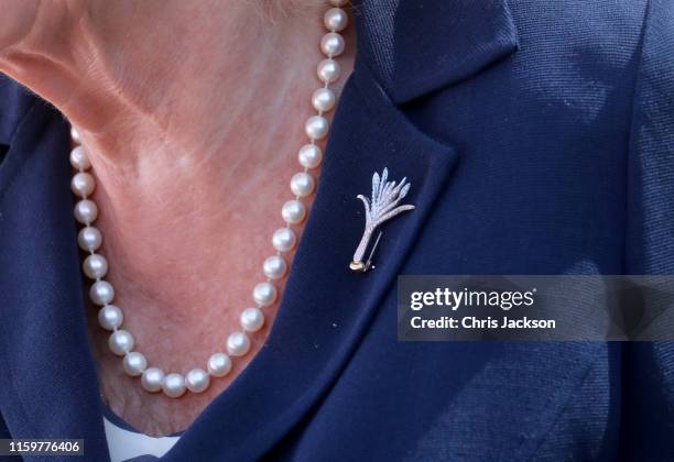 Camilla, Duchess of Cornwall wears a Welsh leek brooch as she visits Victoria Park and the Patti Pavilion for a celebration of the 50th anniversary...