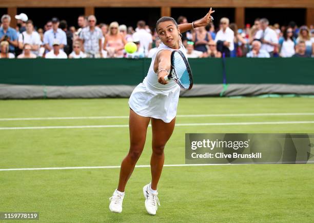 Eden Silva of Great Britain plays a backhand in their Ladies' Doubles first round match against Sorana Cirstea of Romania and Galina Voskoboeva of...