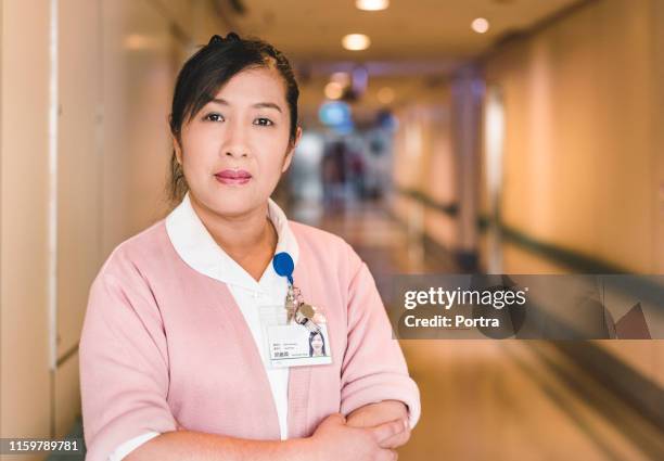 portrait of confident female doctor in hospital - doctor authority stock pictures, royalty-free photos & images