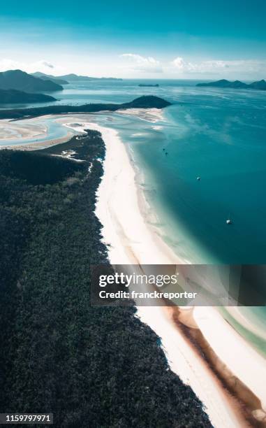 whitsunday beach met een boot - whitsunday island stockfoto's en -beelden