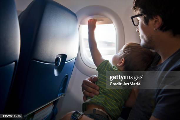 naughty boy travelling by plane - inconvenience imagens e fotografias de stock