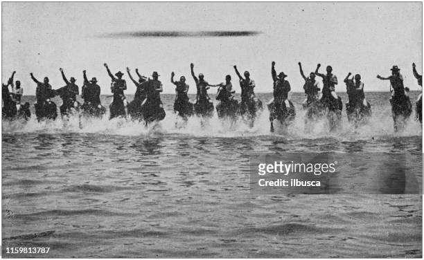 us army black and white photos: cavalry charging in the sea - horse running water stock illustrations
