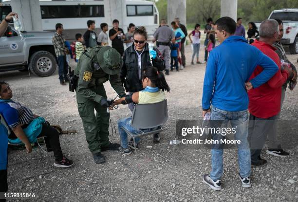 Border Patrol medic treats an immigrant for heat exhaustion after taking her into custody on July 02, 2019 in McAllen, Texas. The immigrants, mostly...