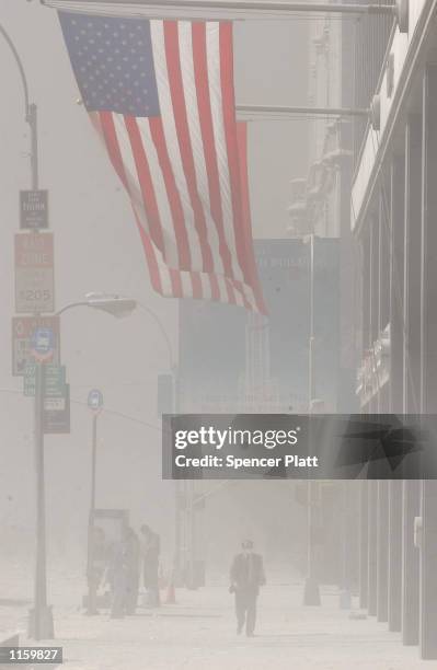 Dust swirls around south Manhattan moments after a tower of the World Trade Center collapsed September 11, 2001 in New York City after two airplanes...