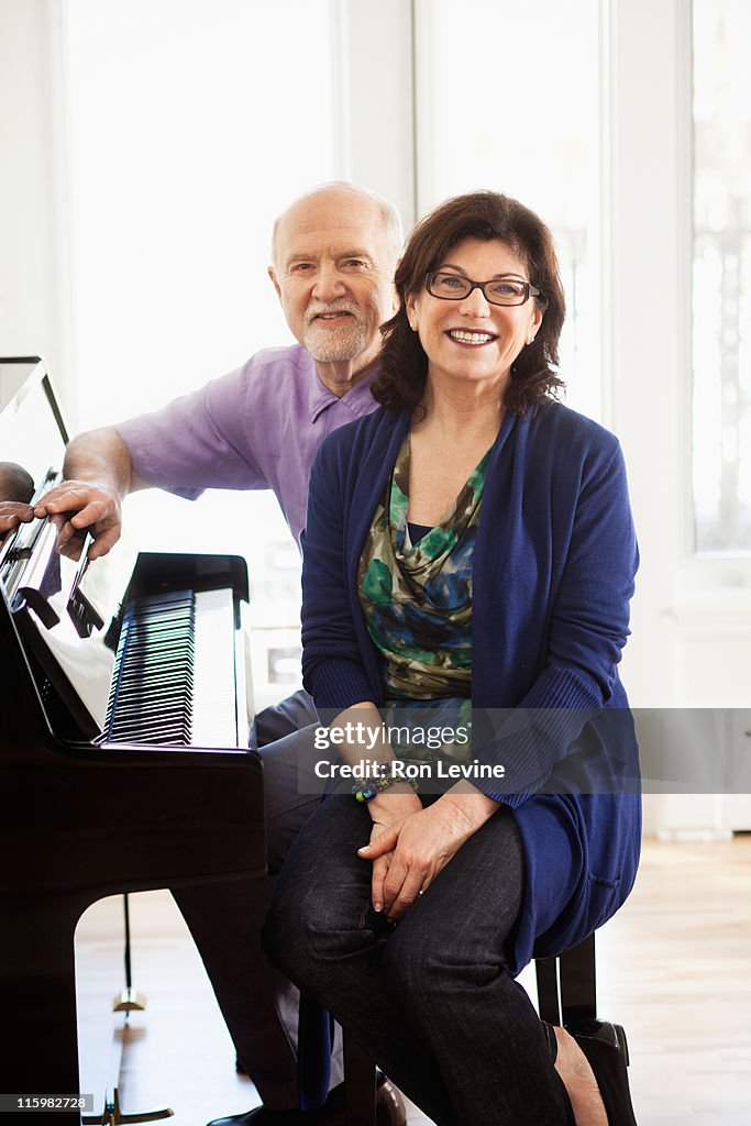 Mature Couple sitting at the piano together