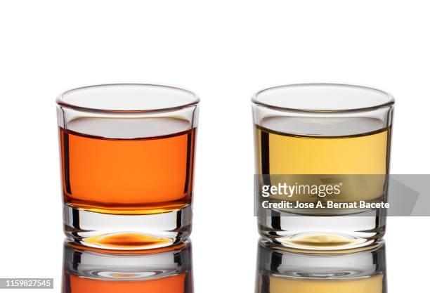 shot glass filled with liquor isolated on white, (shot of spirit). - tequila stock-fotos und bilder