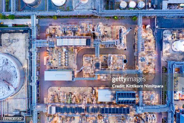 aerial view of twilight of oil refinery ,shot from drone of oil refinery plant ,refinery petrochemical plant at dusk , bangkok, thailand. - oil industry stock-fotos und bilder