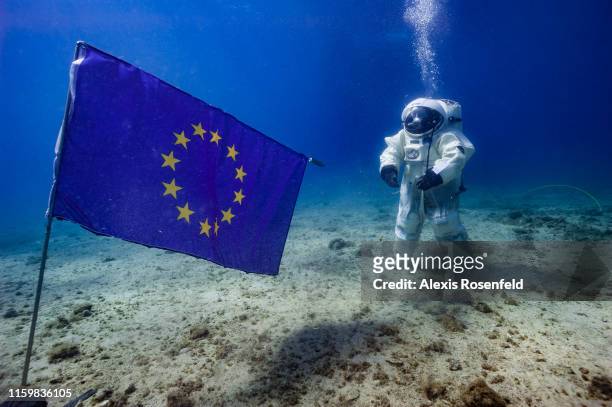 French astronaut Jean-François Clervoy of the European Space Agency in a space suit attempts a Moonwalk under the sea on September 4, 2013 off the...