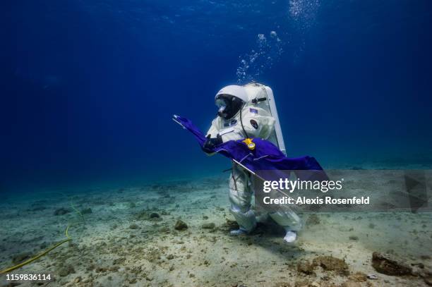 French astronaut Jean-François Clervoy of the European Space Agency in a space suit attempts a Moonwalk under the sea on September 4, 2013 off the...