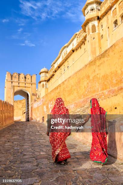 two indian women on the way to amber fort, india - amer fort stock pictures, royalty-free photos & images